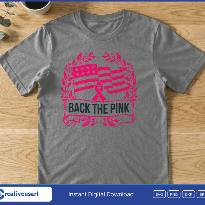 A pink US flag and breast cancer ribbon in a laurel wreath above the words Back The Pink, on a gray t-shirt
