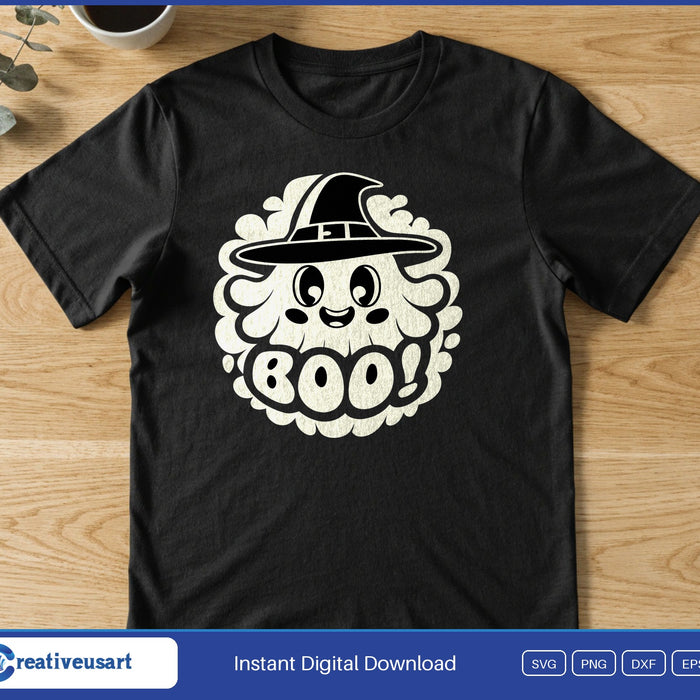 A smiling ghost in a witch hat inside a round cloud badge, above the word Boo!, on a black t-shirt
