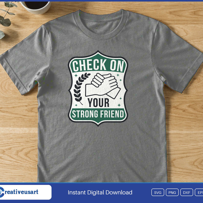 A handshake inside a green badge reading Check On Your Strong Friend, on a gray t-shirt