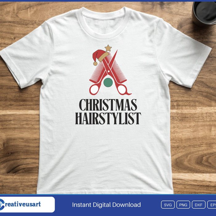 Hair scissors shaped like a Christmas tree in a Santa hat, above the words Christmas Hairstylist, on a white t-shirt
