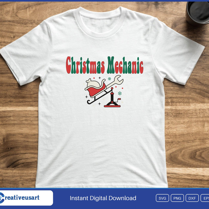 Santa's sleigh raised on a floor jack with a wrench, below the words Christmas Mechanic, on a white t-shirt