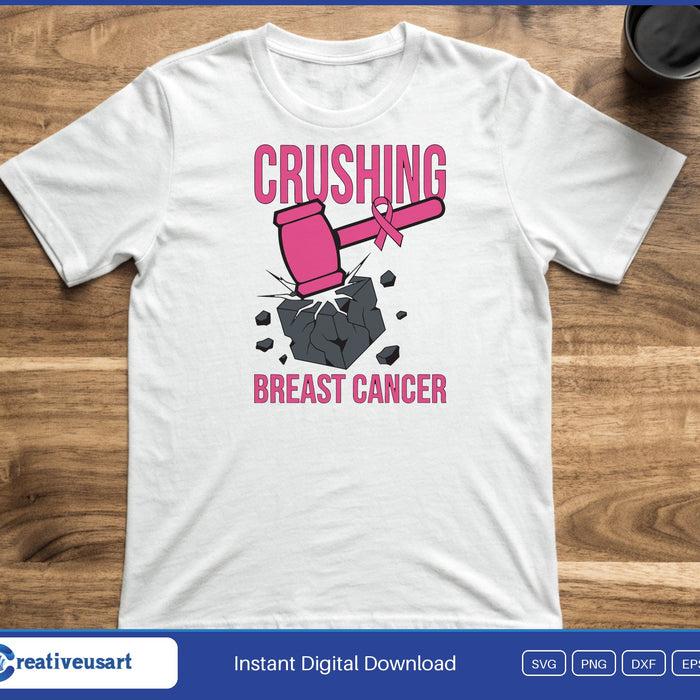 A pink sledgehammer smashing a rock, between the words Crushing and Breast Cancer, on a white t-shirt
