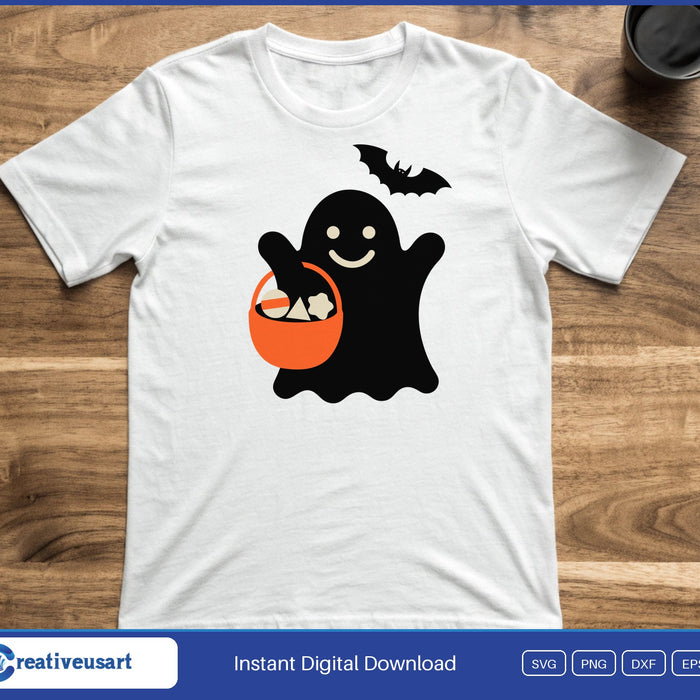 A smiling black ghost holding an orange candy bucket with a small bat above, on a white t-shirt