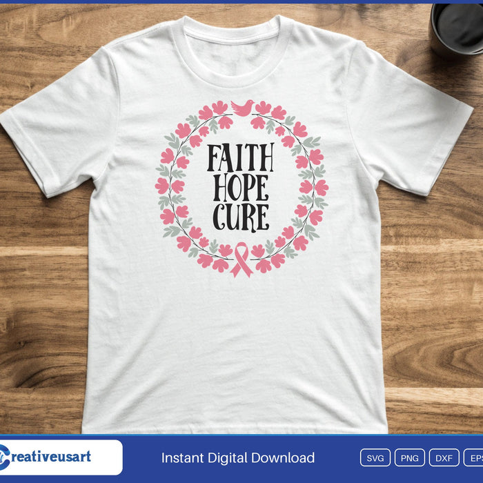 A round wreath of pink flowers with a small pink ribbon, around the words Faith Hope Cure, on a white t-shirt