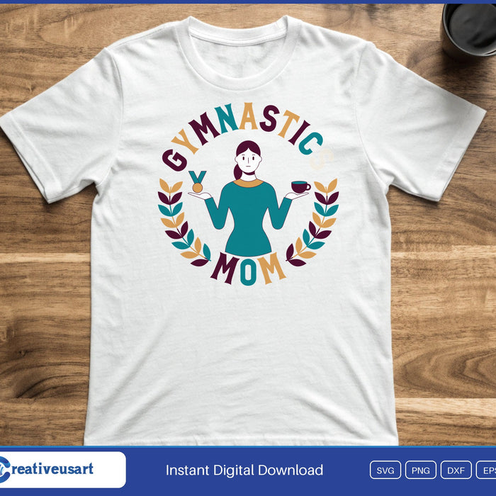 A woman holding a medal and a coffee cup inside a laurel wreath, with the words Gymnastic Mom, on a white t-shirt