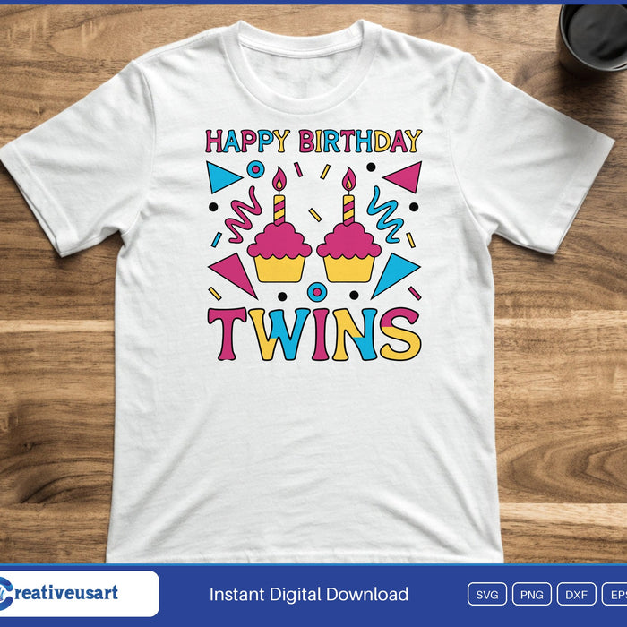 Two pink cupcakes with candles between party flags, with the words Happy Birthday Twins, on a white t-shirt