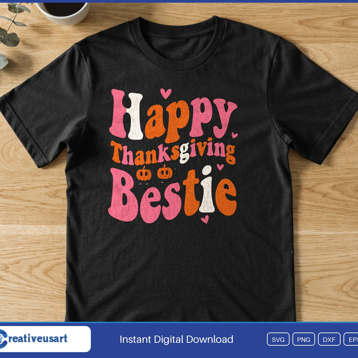 Retro pink, orange and white words Happy Thanksgiving Bestie with two tiny pumpkins and hearts, on a black t-shirt