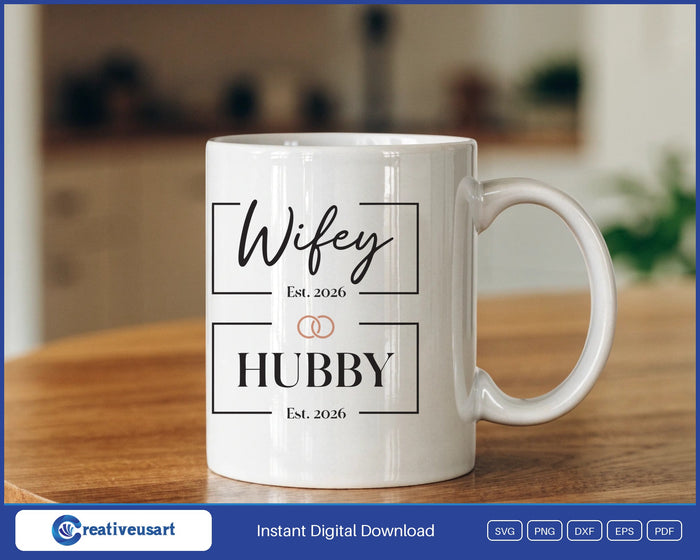 Hubby and Wifey 2026 wedding rings SVG design on a white coffee mug
