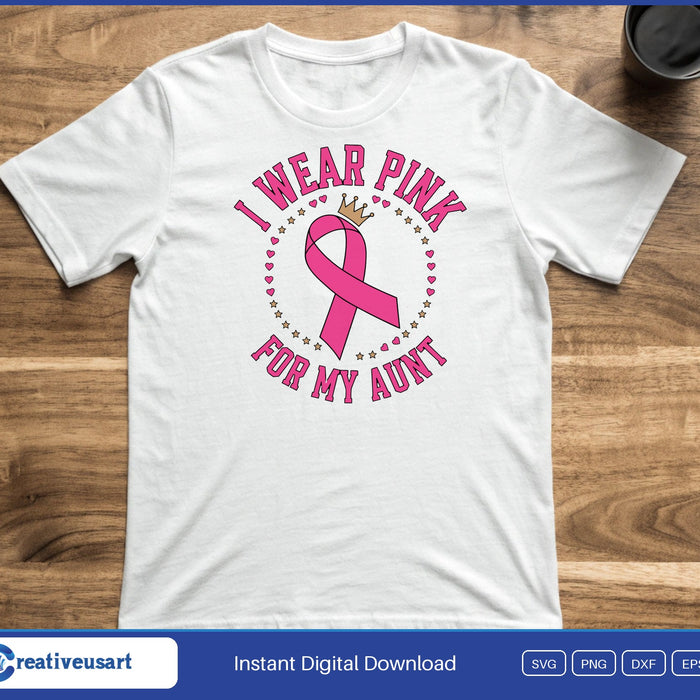 A pink ribbon with a gold crown inside a ring of small hearts, between the words I Wear Pink For My Aunt, on a white t-shirt