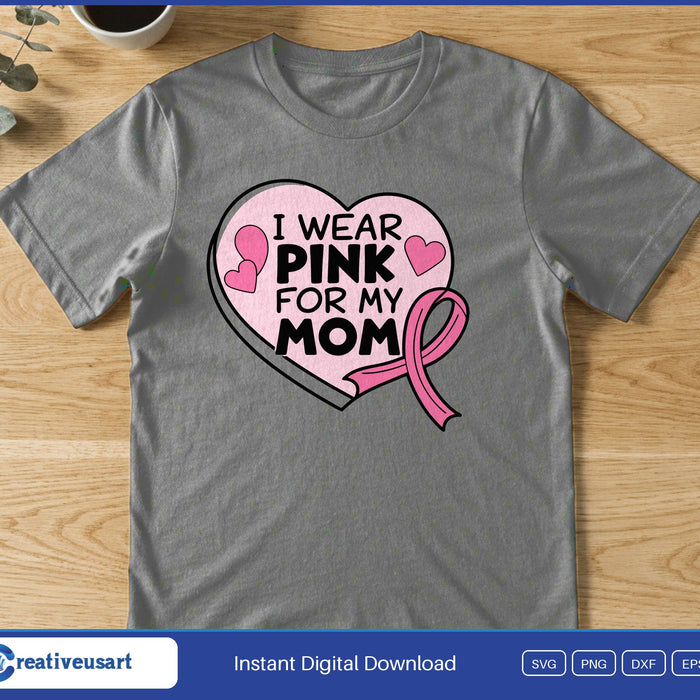A pink heart with small hearts and a pink ribbon around the bold words I Wear Pink For My Mom, on a gray t-shirt