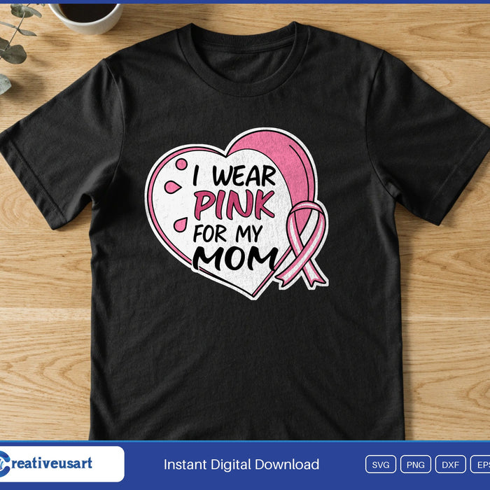 A white and pink heart with a pink ribbon, around the words I Wear Pink For My Mom, on a black t-shirt