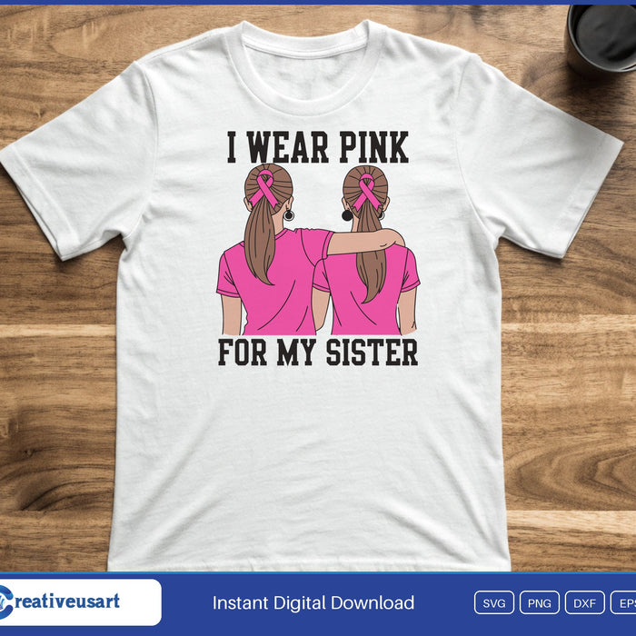 Two sisters arm in arm with pink ribbons in their hair, between the words I Wear Pink For My Sister, on a white t-shirt