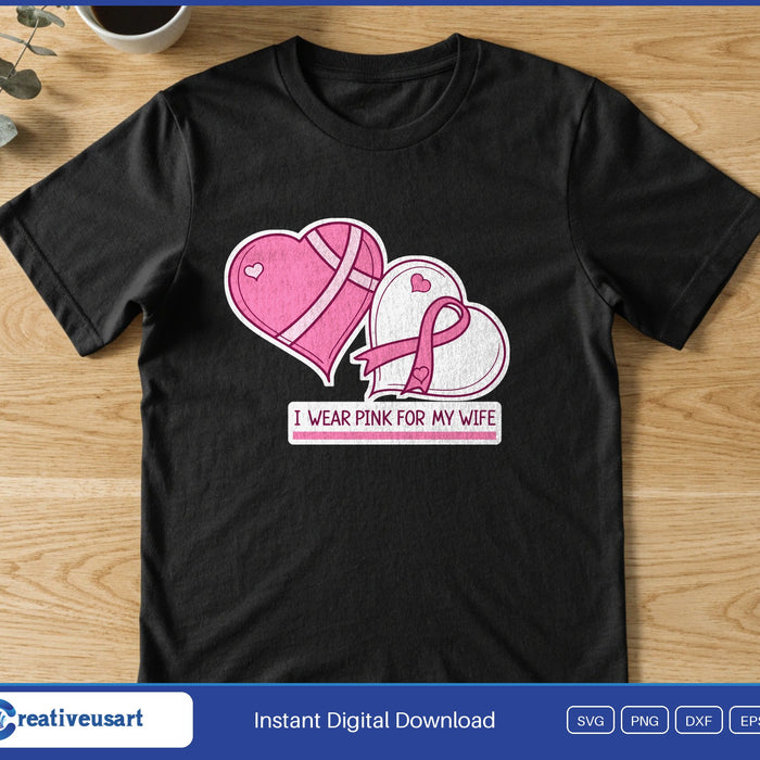 Two pink hearts, one with a pink ribbon, above the words I Wear Pink For My Wife, on a black t-shirt