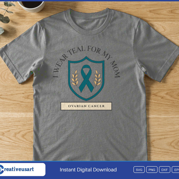 A teal ribbon on a shield crest under I Wear Teal For My Mom, above Ovarian Cancer, on a gray t-shirt