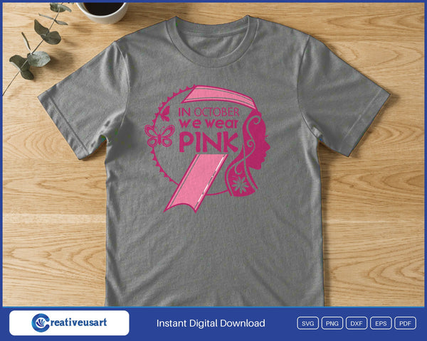 A woman's profile inside a pink awareness ribbon with the words In October We Wear Pink, on a gray t-shirt