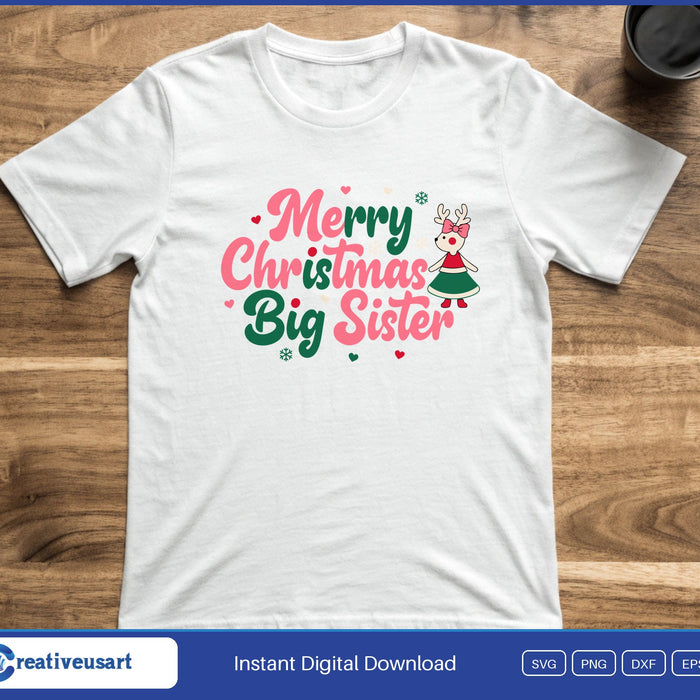 A little reindeer girl in a green dress beside the words Merry Christmas Big Sister in pink and green, on a white t-shirt