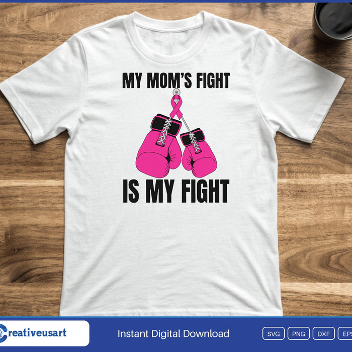 Pink boxing gloves hanging from a pink ribbon, between the words My Mom's Fight Is My Fight, on a white t-shirt