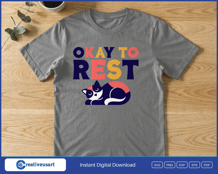 A black and white cat curled up asleep below the words Okay To Rest, on a gray t-shirt