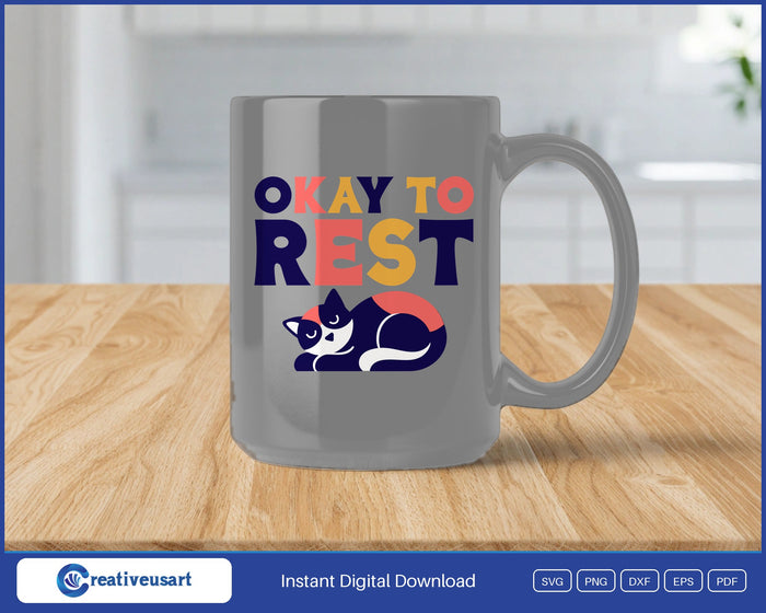 Okay To Rest sleeping cat SVG design on a grey coffee mug