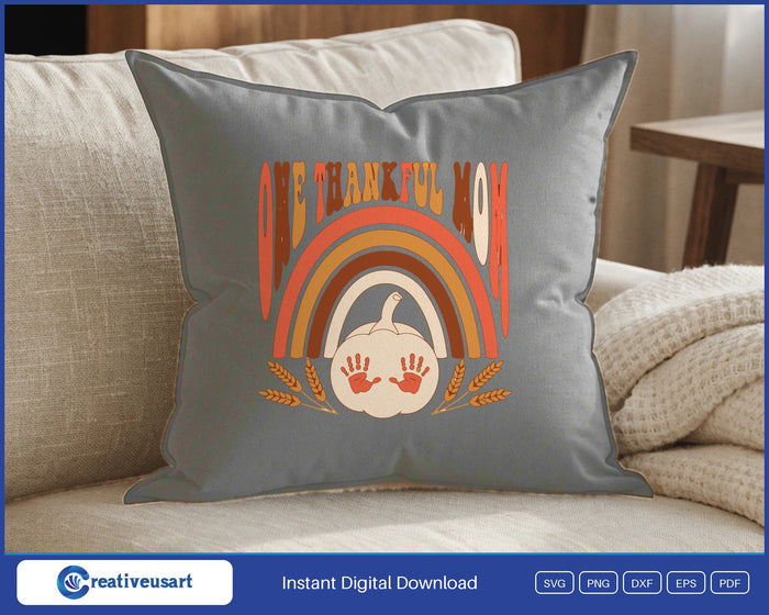 One Thankful Mom retro rainbow with a pumpkin and handprints SVG design on a gray throw pillow