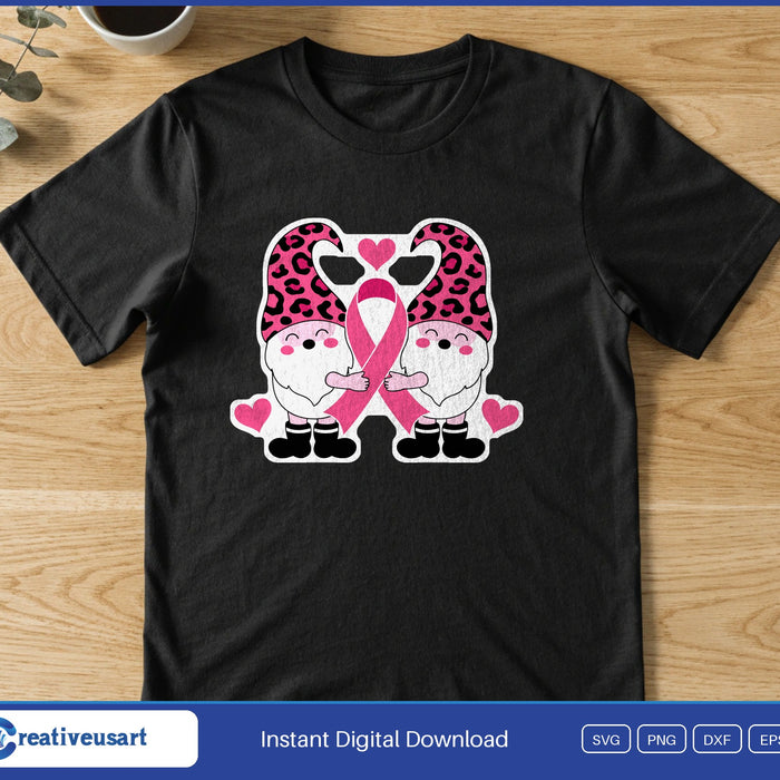 Two gnomes in pink leopard print hats holding a pink ribbon, with small hearts, on a black t-shirt