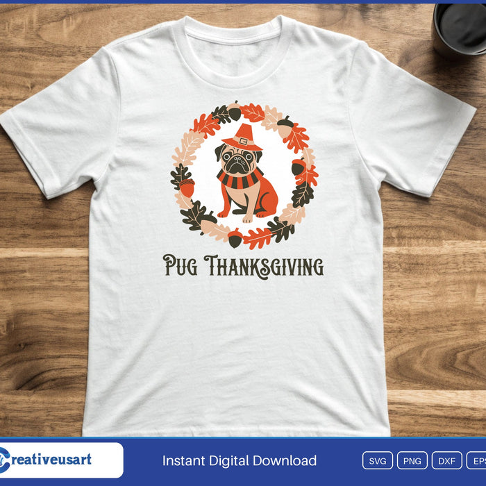 A pug in a pointed orange hat inside a wreath of autumn leaves, above the words Pug Thanksgiving, on a white t-shirt