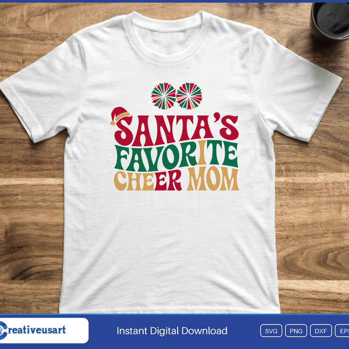 Two red and green pom poms above retro letters reading Santa's Favorite Cheer Mom with a Santa hat, on a white t-shirt