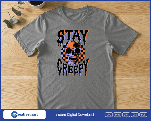 A checkered skull in sunglasses between the dripping words Stay Creepy, on a gray t-shirt