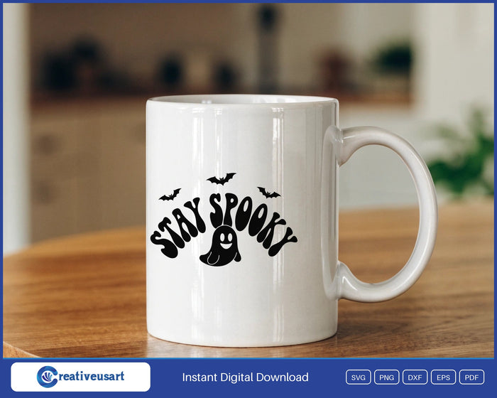 Stay Spooky retro ghost and bats Halloween SVG design on a white coffee mug