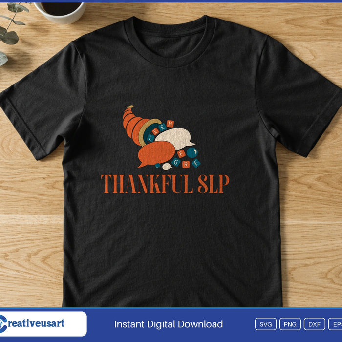 A cornucopia spilling autumn vegetables above the words Thankful SLP, on a black t-shirt
