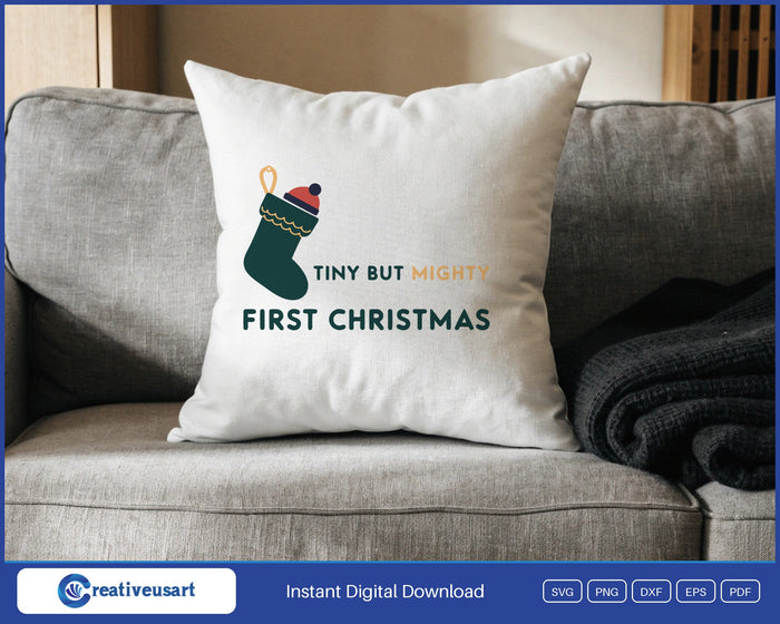 Tiny But Mighty First Christmas with a small stocking and knitted hat SVG design on a white throw pillow