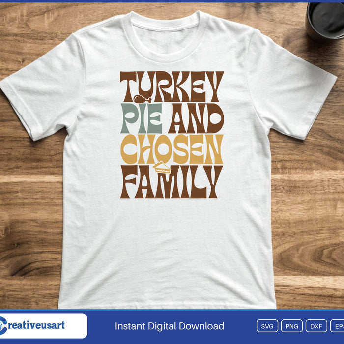 Stacked retro lettering reading Turkey Pie and Chosen Family in brown, orange and gold, on a white t-shirt